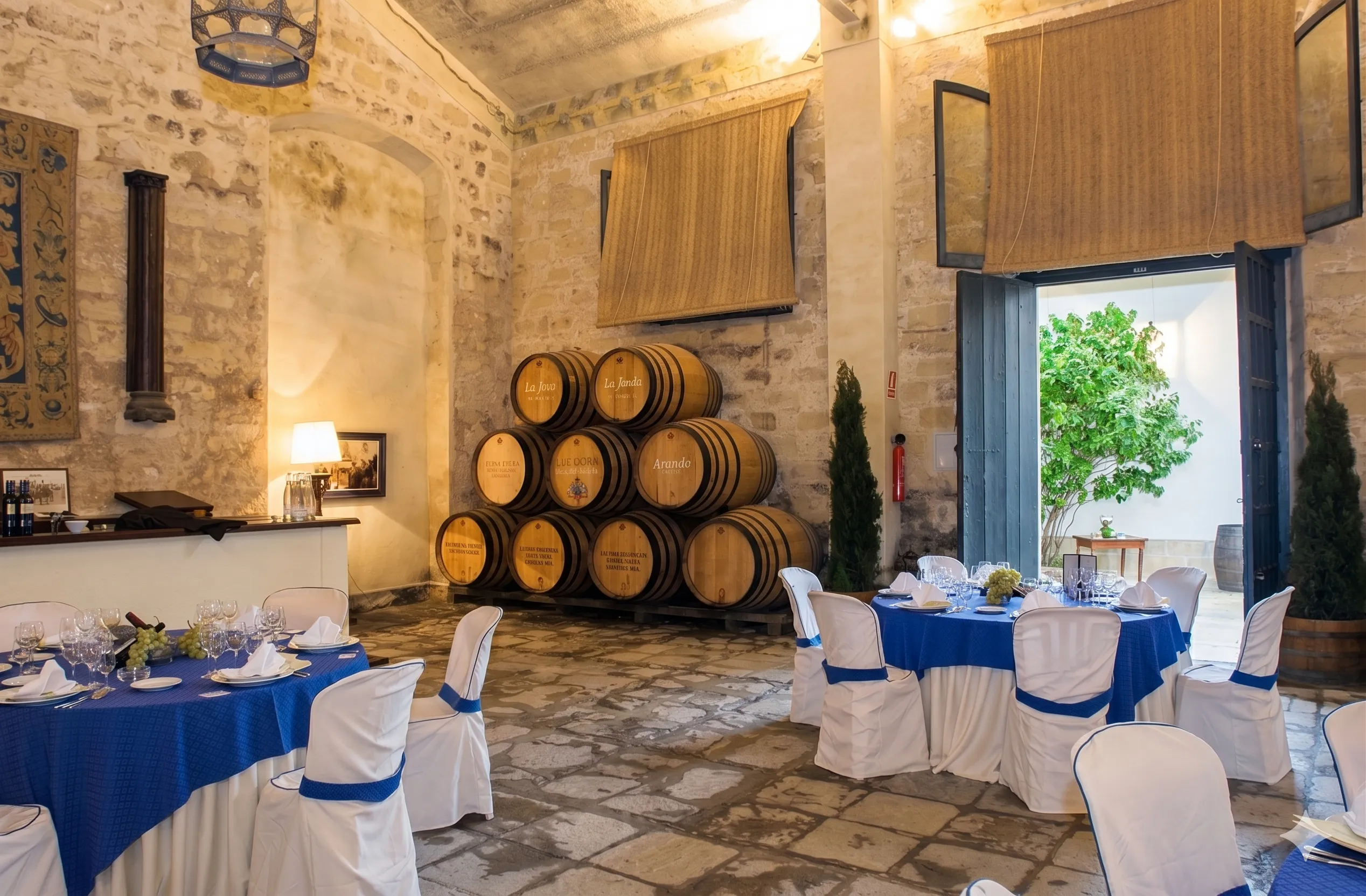 Detalle del interior de la bodega con mesas decoradas para un evento o celebración. Esta imagen se utiliza para ilustrar una entrada sobre qué tener en cuenta al organizar un evento en una bodega.